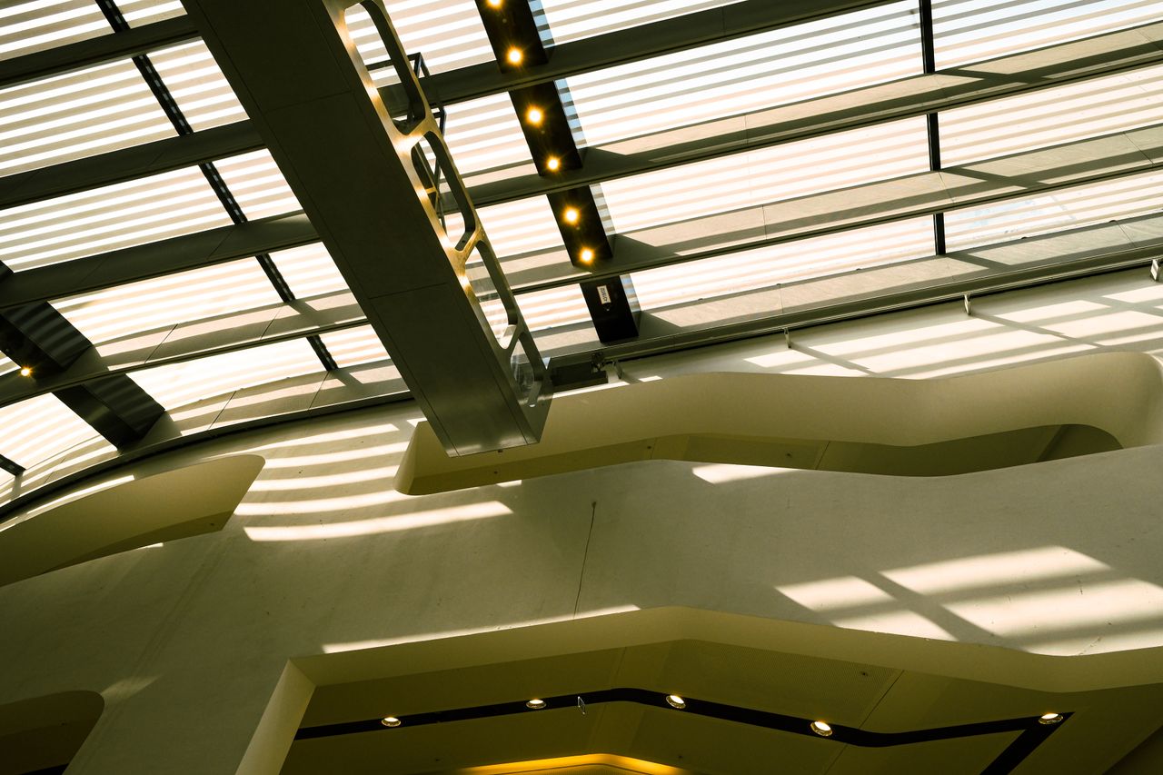 A contemporary ceiling design casting geometric shadows, showcasing modern architecture.